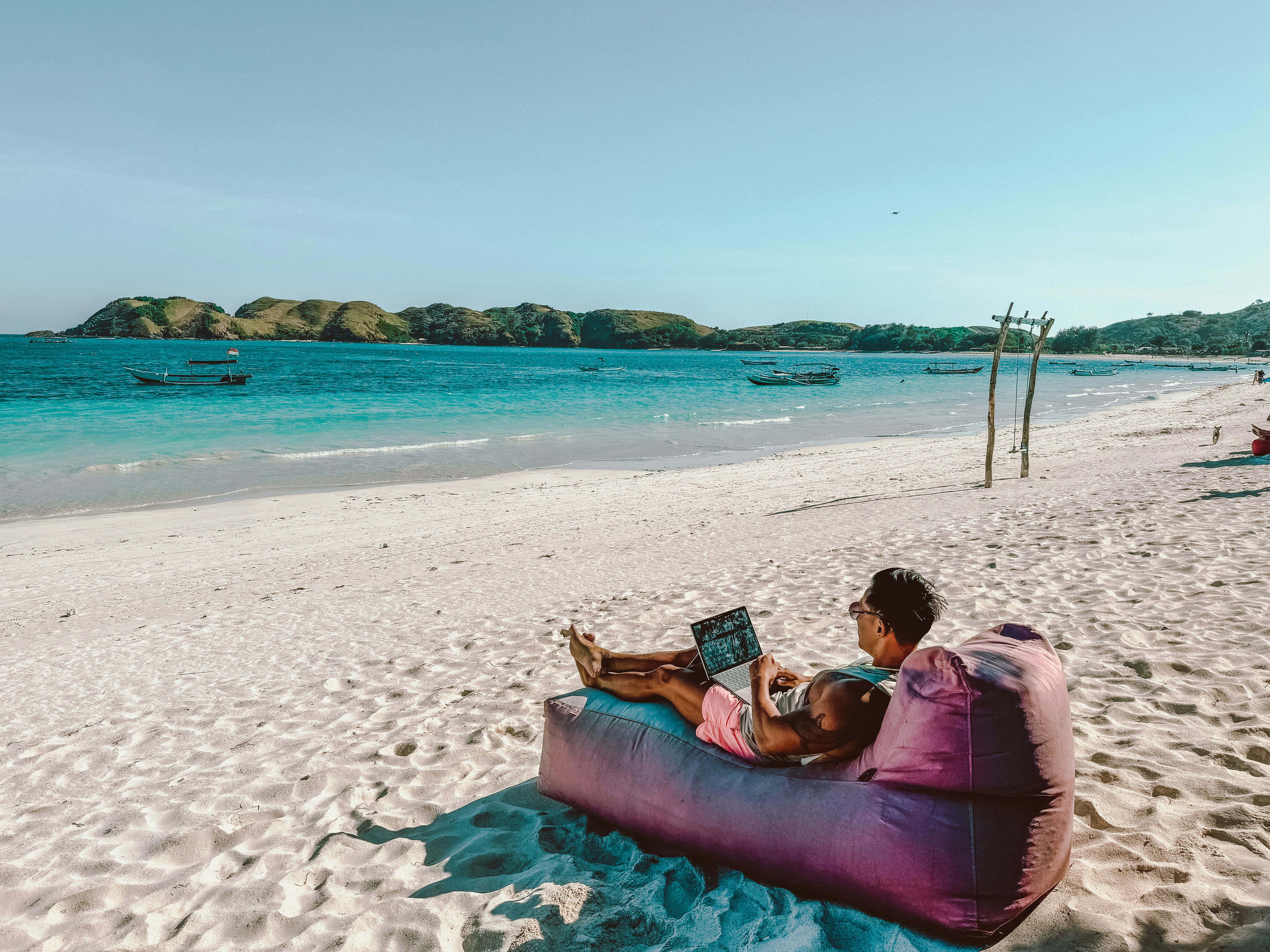 Remote worker with laptop on the beach in Playa del Carmen